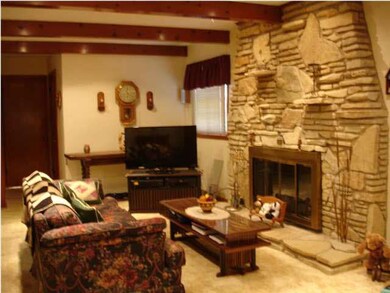 The Family Room with stone gas log fireplace is pe