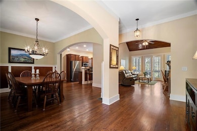 Dining room featuring crown molding, baseboards, d