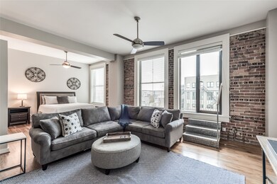 Exposed brick wall runs through Living Room and Be