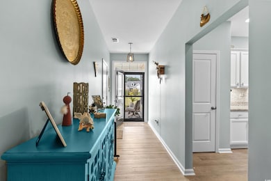 Entryway with baseboards, visible vents, and light