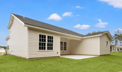 Rear view of house with a patio, a lawn, a shingled roof, and ceiling fan