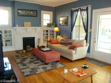 Living Room. Living Room with coal burning fireplace, Hardwood Floors, Notice the built in shelving and plenty of room