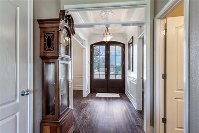 Grand foyer with doubles doors and high ceilings