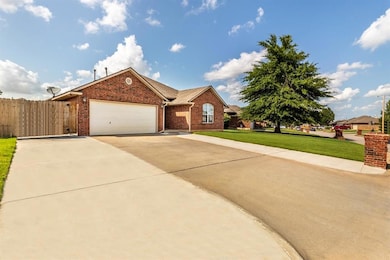 View of front of home featuring brick siding, concrete driveway, and a garage