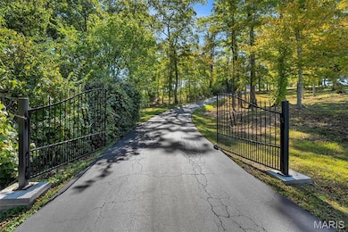 View of road featuring a gate and a gated entry