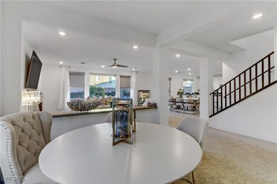 Dining space featuring light carpet, stairs, a cei
