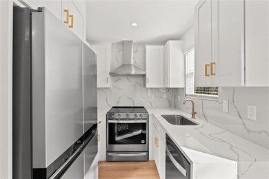 Kitchen with stainless steel appliances, wall chi