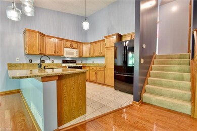 Kitchen featuring wood cabinets, pendant light fix