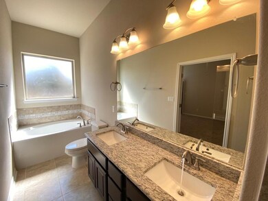 Full bath with a bath, double vanity, tile patter