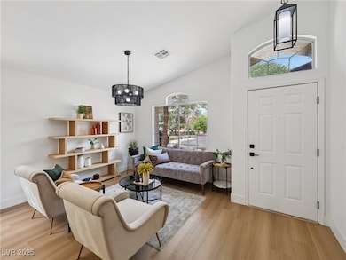 Living area with a chandelier, light wood-style fl