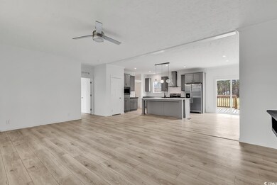 Unfurnished living room with ceiling fan, recessed