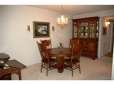 Formal Dining room with newer carpet and chandelie