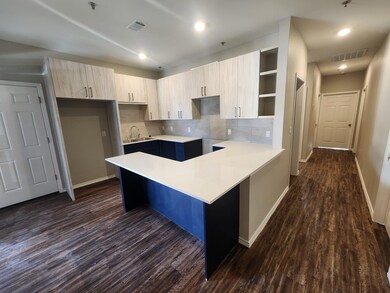 Kitchen with open shelves, baseboards, a sink, da