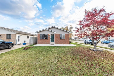 View of front facade featuring brick siding and a patio area