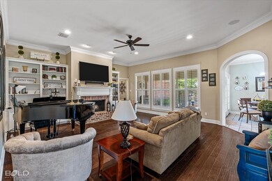 Living room featuring ceiling fan, dark wood-type 