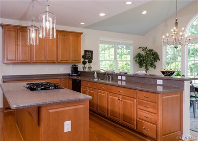 The kitchen has a center island with gas cooktop a