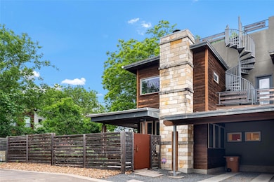 View of side of property with a chimney, fence, a