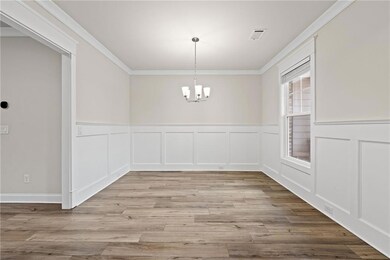 Unfurnished dining area with an inviting chandelie