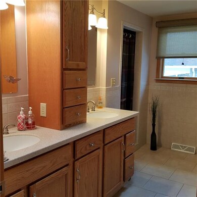 SPACIOUS, UPDATED BATH WITH STORAGE AND CERAMIC TI
