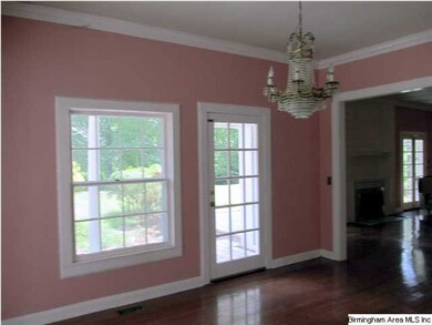 Formal dining room with arch going into the living