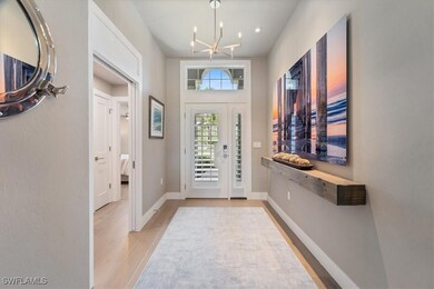 Entryway with a chandelier and light wood finished