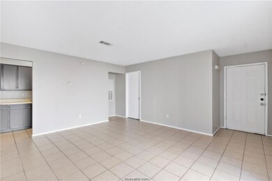 Unfurnished living room featuring light tile patte