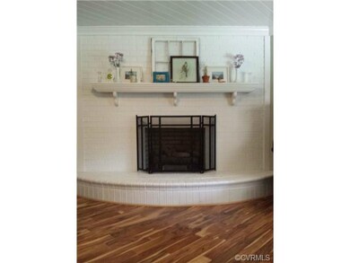 Curved brick fireplace near the front entrance.