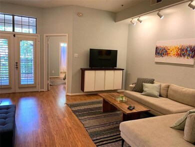 Large living room featuring track lighting and hig