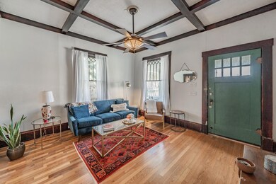 Living room featuring beamed ceiling, coffered cei