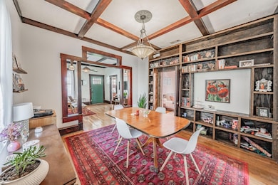 Dining space featuring coffered ceiling, beamed ce