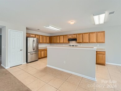 The center island features a breakfast bar.