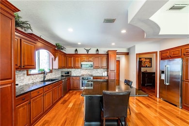 Stunning Kitchen with Wood cabinet and oversized i