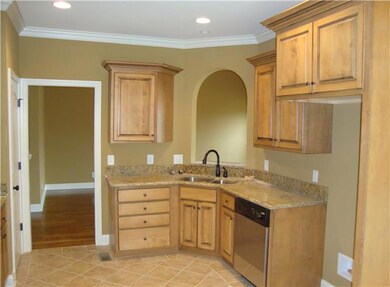 Kitchen with Tile Flooring, Custom Maple Cabinets, and Pantry