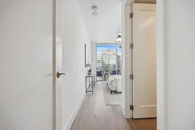 Corridor featuring floor to ceiling windows, hard