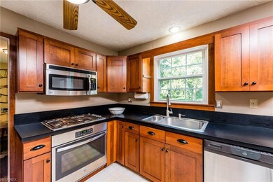 Stainless steel appliances and cherry cabinetry.