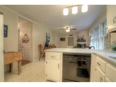 Kitchen with serving bar, recently opened to sitti