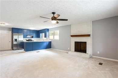 Den with brick fireplace