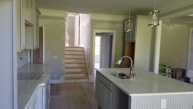 Alternate view of kitchen with views of hardwood steps.  Stairs are split with the bonus room in between - great setup!!! (not actual home for sale.)