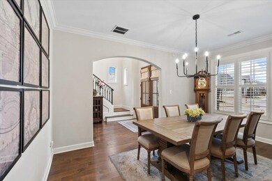 Dining space featuring ornamental molding, dark ha