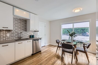 Kitchen featuring dishwasher, a sink, light wood-