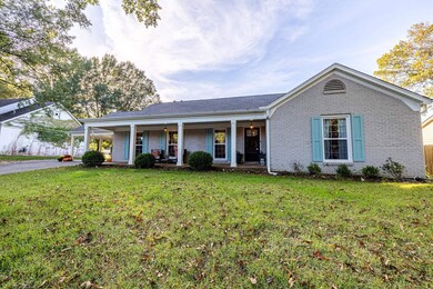 Ranch-style home with a front yard and covered por