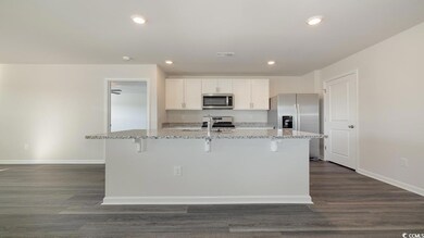 Kitchen featuring white cabinetry, appliances with