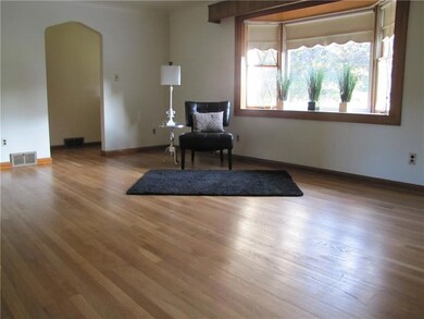 Gleaming , just refinished hardwood, a large windo