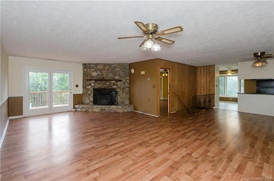 Main level living room with stone fireplace (Woods