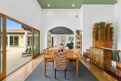Dining area with arched walkways, a wealth of nat