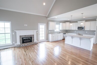 Kitchen opens up to living room. Same floor plan in different color palette.