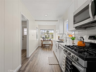 Remodeled kitchen features tons of cabinet space and recessed lights