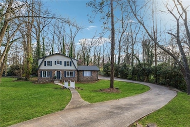 Colonial inspired home featuring a front lawn, bri