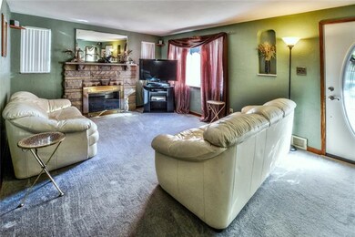 The spacious living room features a log burning fi