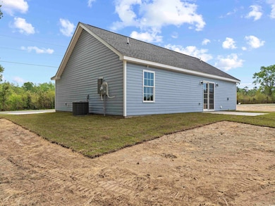 Rear view of house with roof with shingles, a yard, and central AC unit